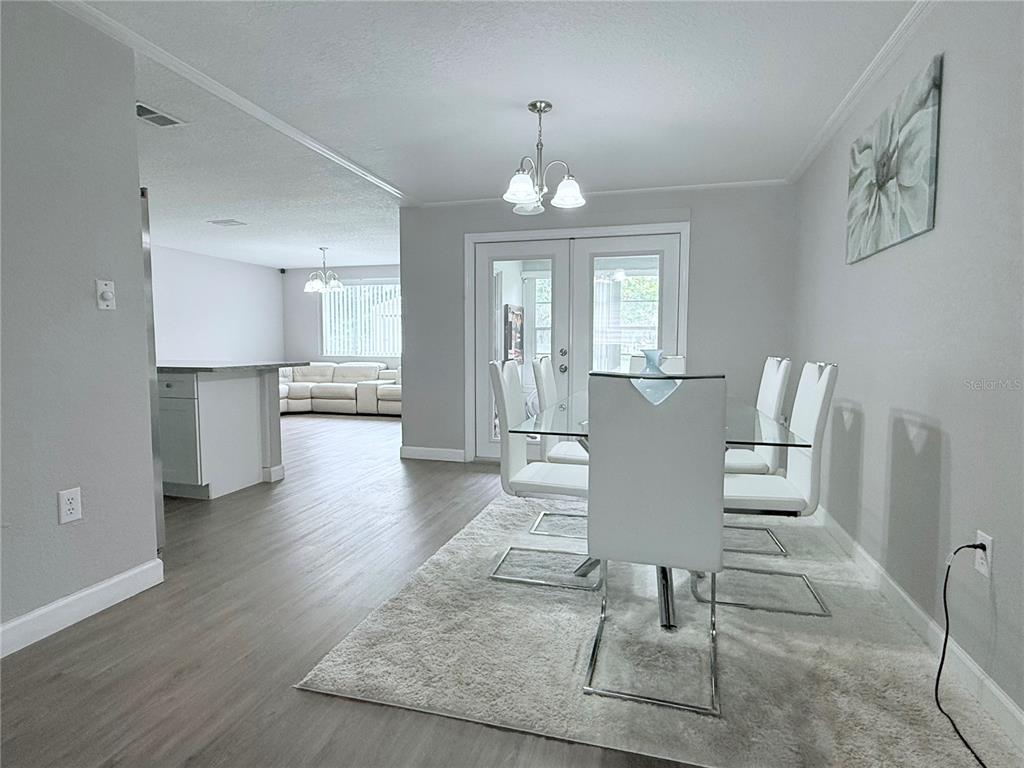 9733 Dick Street Hudson, FL 34669 - Photo 38 of 40 a view of a kitchen and dining area with chandelier