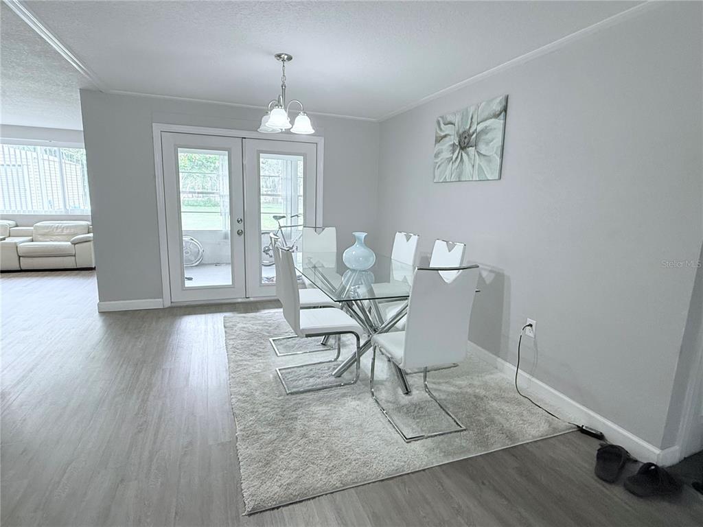 9733 Dick Street Hudson, FL 34669 - Photo 39 of 40 a view of a dining room with furniture window and wooden floor