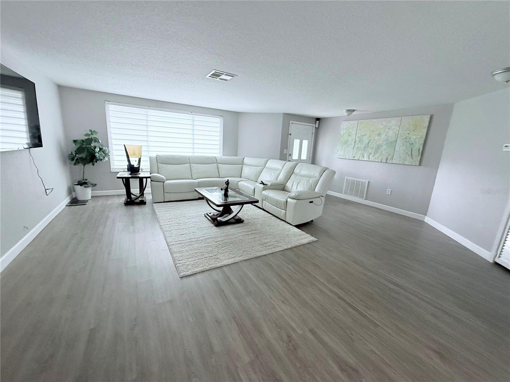 9733 Dick Street Hudson, FL 34669 - Photo 40 of 40 a living room with furniture and a wooden floor