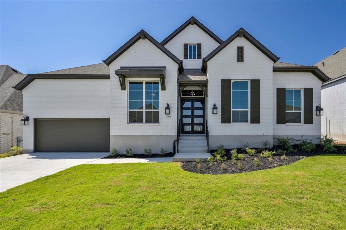 1300 Firebush Road Leander, TX 78641 - Photo 1 of 1 a front view of a house with a yard and garage