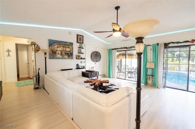 a living room with furniture and view of kitchen