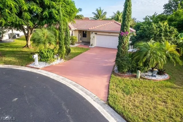 a front view of house with yard and green space