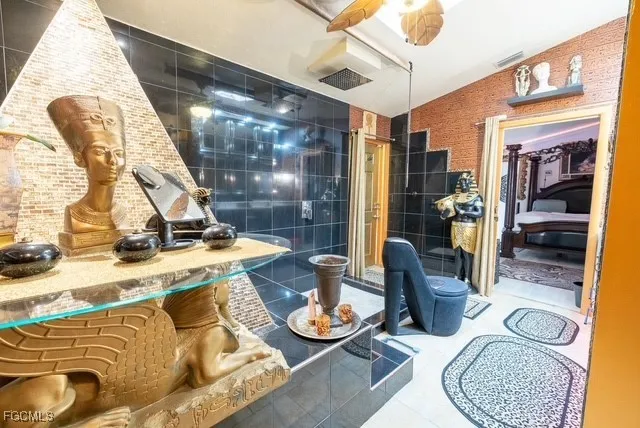 a bedroom with a large bed and a chandelier