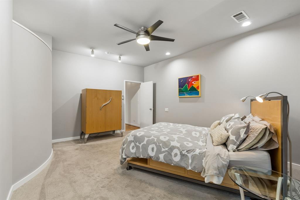 4139 Travis Street Dallas, TX 75204 - Photo 13 of 26 a bedroom with a bed and a ceiling fan