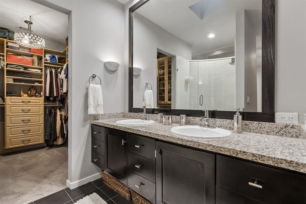 4139 Travis Street Dallas, TX 75204 - Photo 16 of 26 a bathroom with a granite countertop sink double vanity and a mirror
