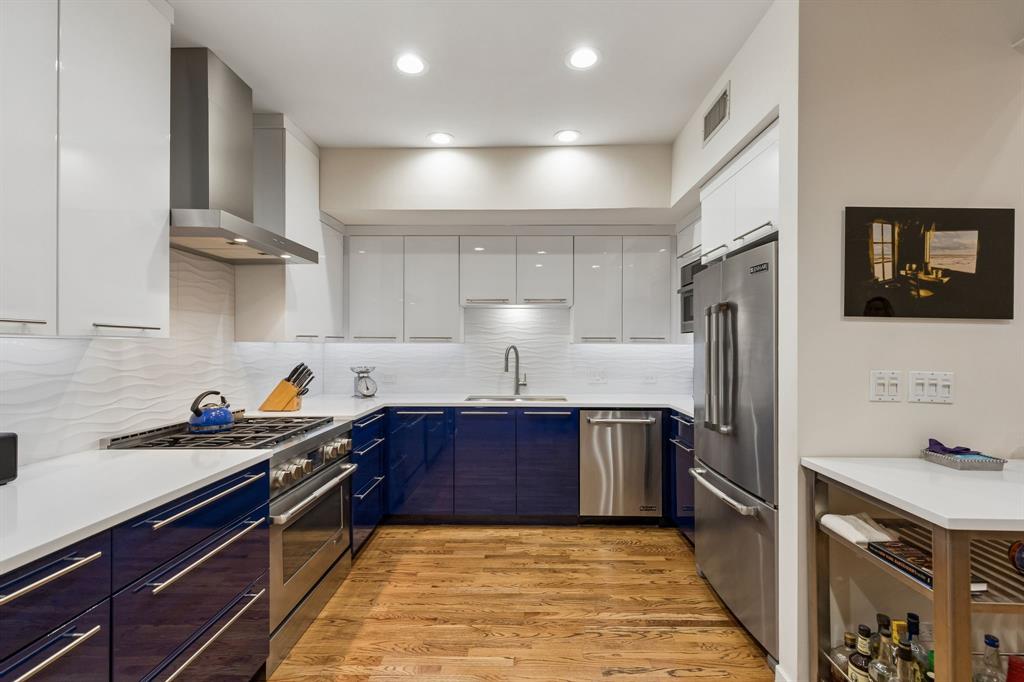4139 Travis Street Dallas, TX 75204 - Photo 7 of 26 a kitchen with stainless steel appliances a sink stove and cabinets