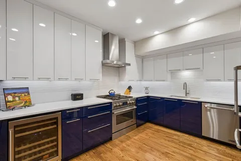a kitchen with a sink a stove and cabinets