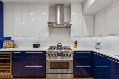 a kitchen with stainless steel appliances granite countertop a stove and a cabinets