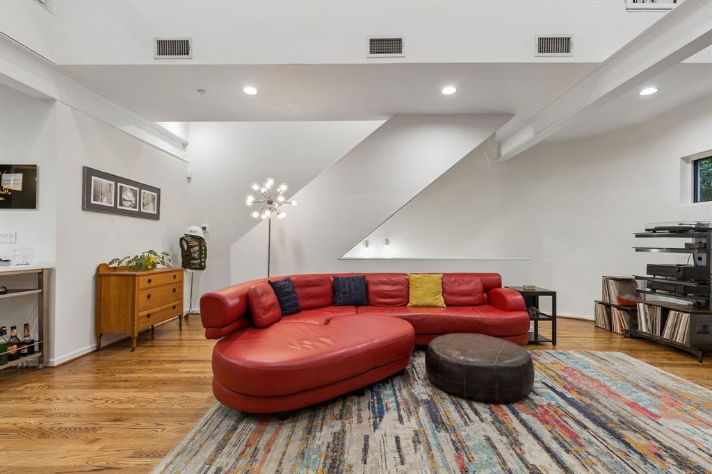 4139 Travis Street Dallas, TX 75204 - Photo 10 of 26 a living room with furniture and a wooden floor
