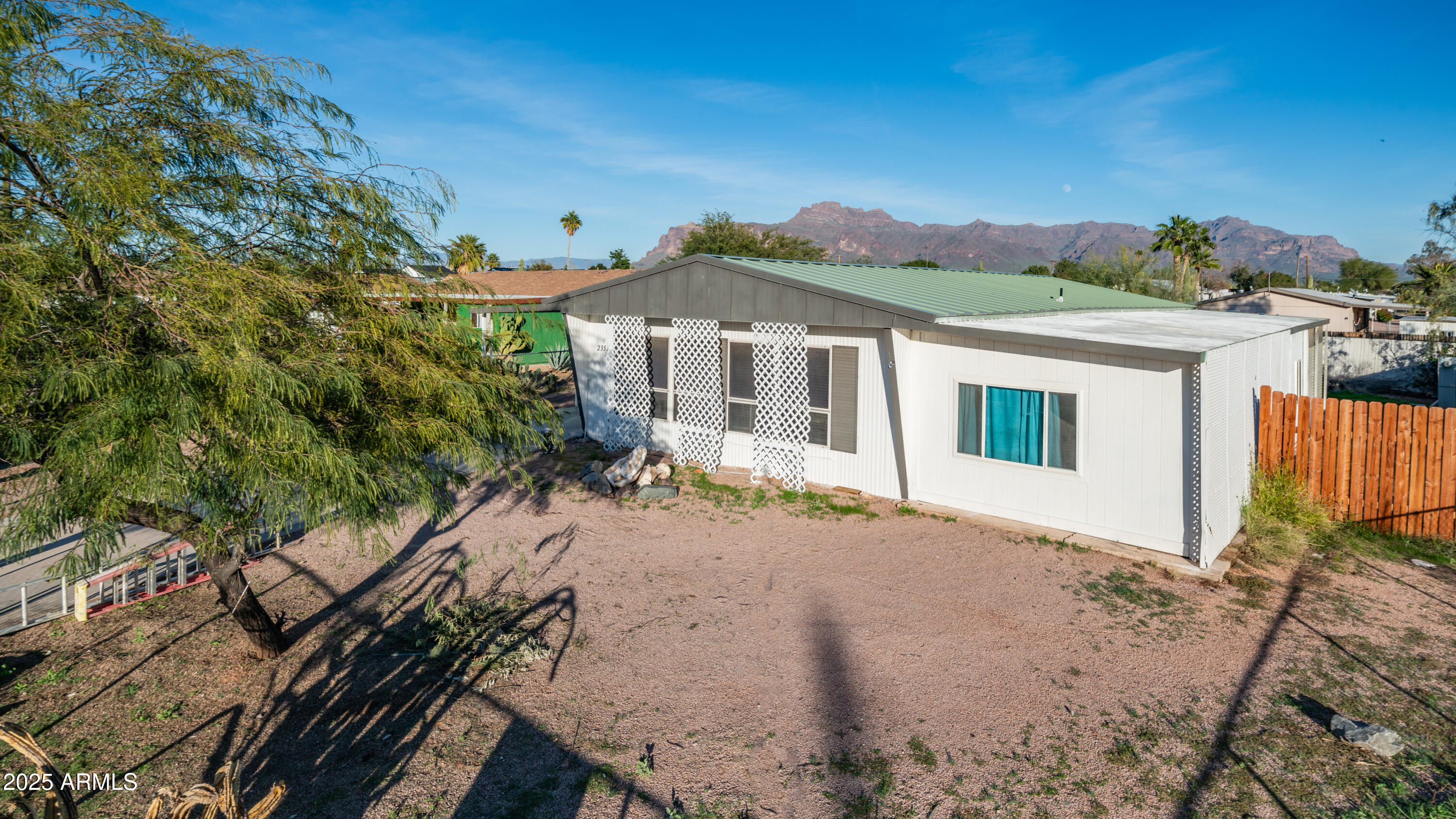 2359 South Tomahawk Road Apache Junction, AZ 85119 - Photo 1 of 32 a view of a white house with a yard