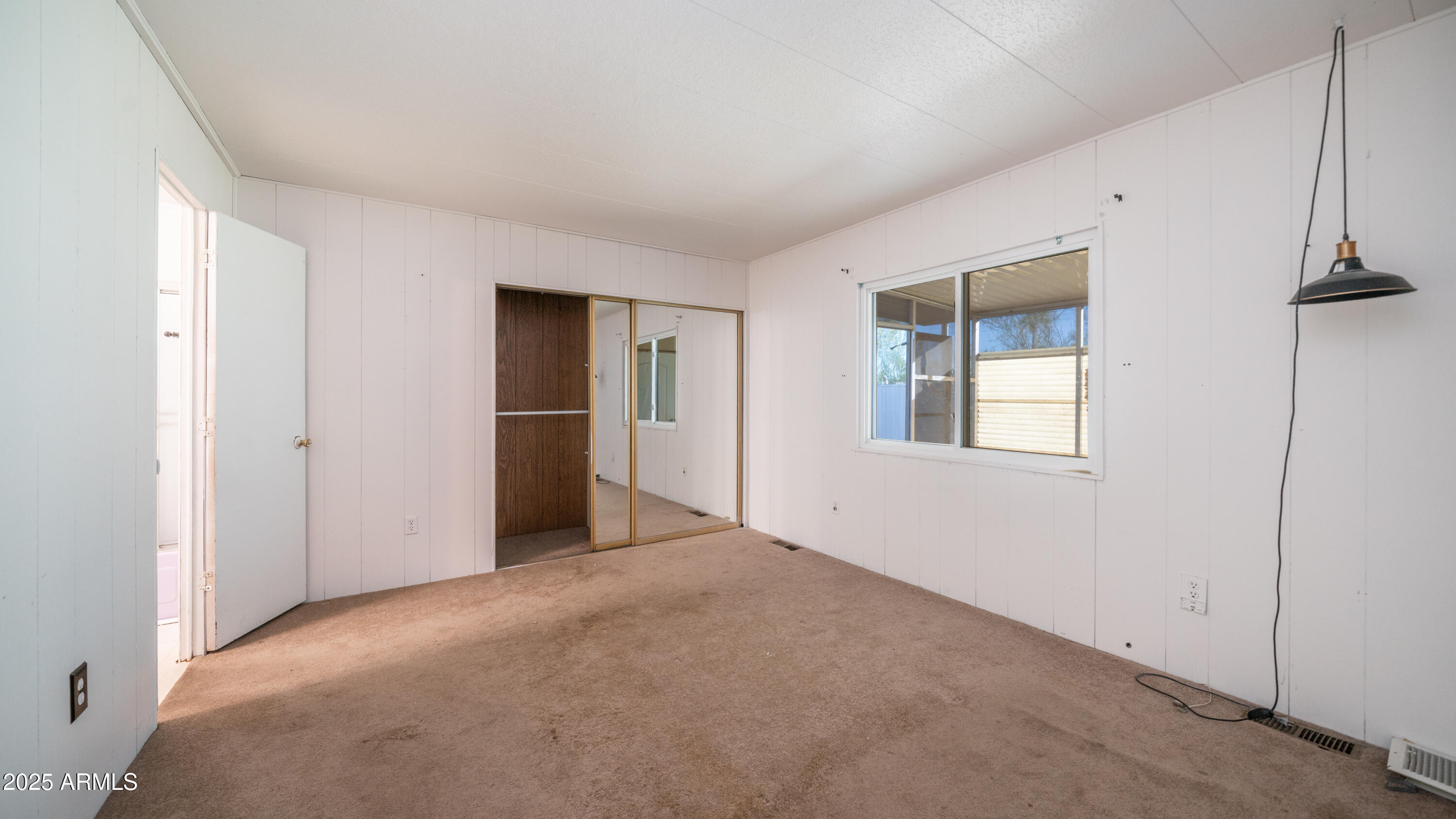 2359 South Tomahawk Road Apache Junction, AZ 85119 - Photo 16 of 32 a view of an empty room with a window