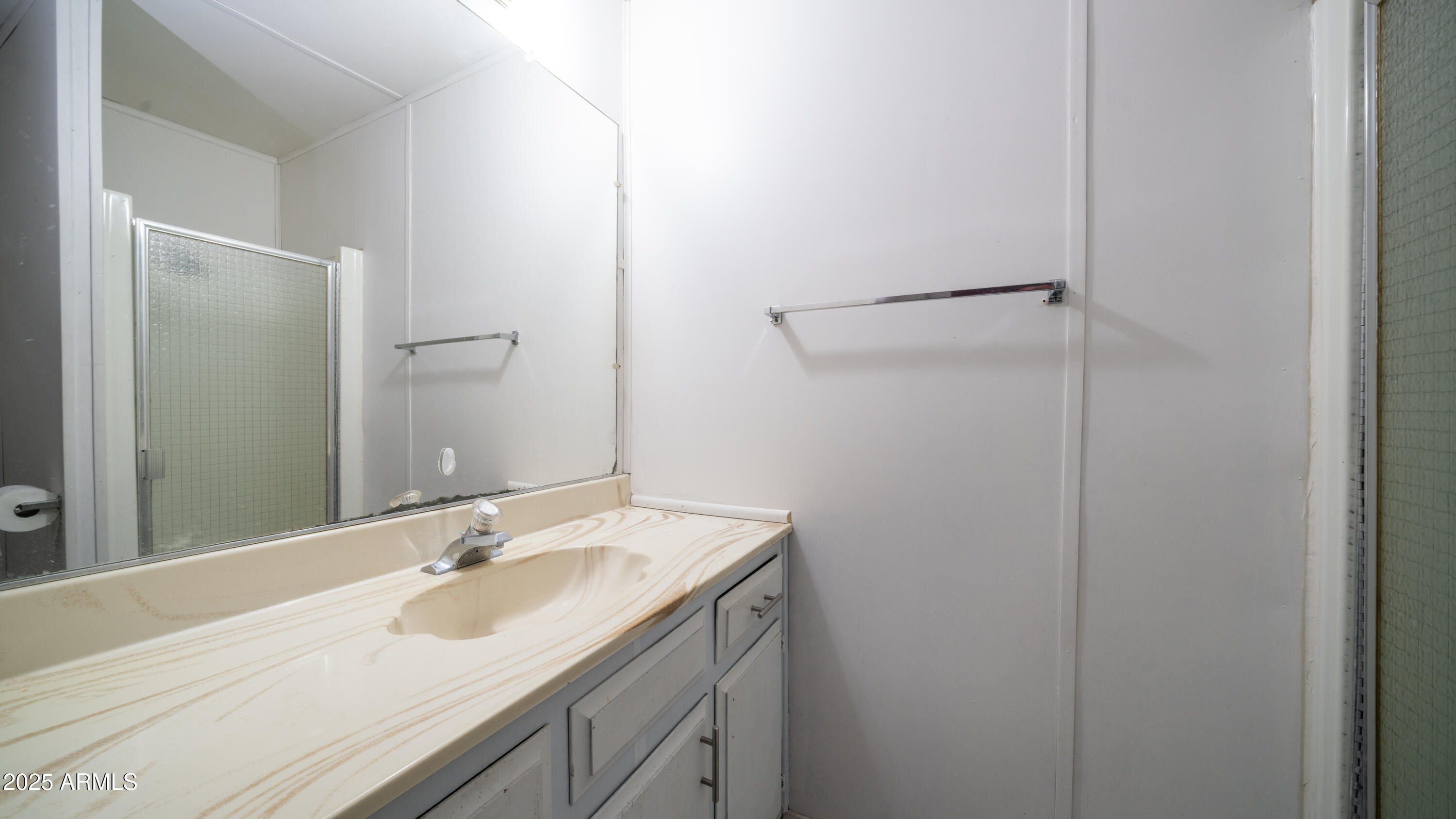 2359 South Tomahawk Road Apache Junction, AZ 85119 - Photo 22 of 32 a bathroom with a sink and a mirror