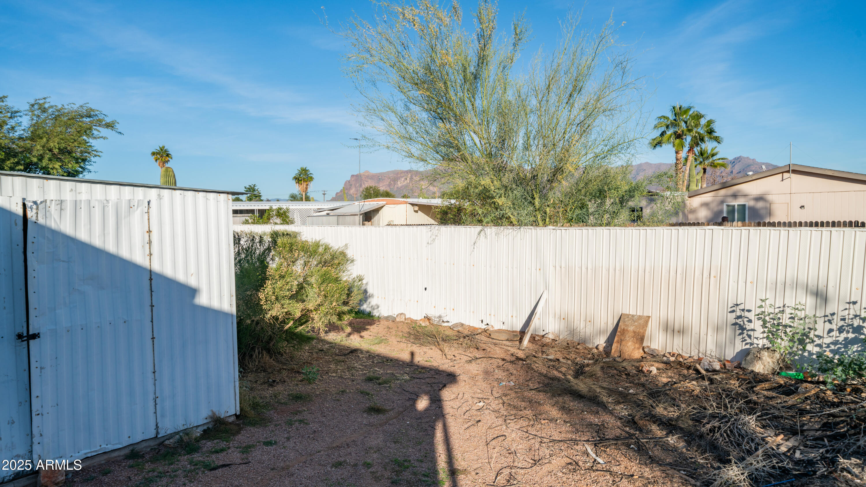 2359 South Tomahawk Road Apache Junction, AZ 85119 - Photo 30 of 32 a view of a garden with wooden fence