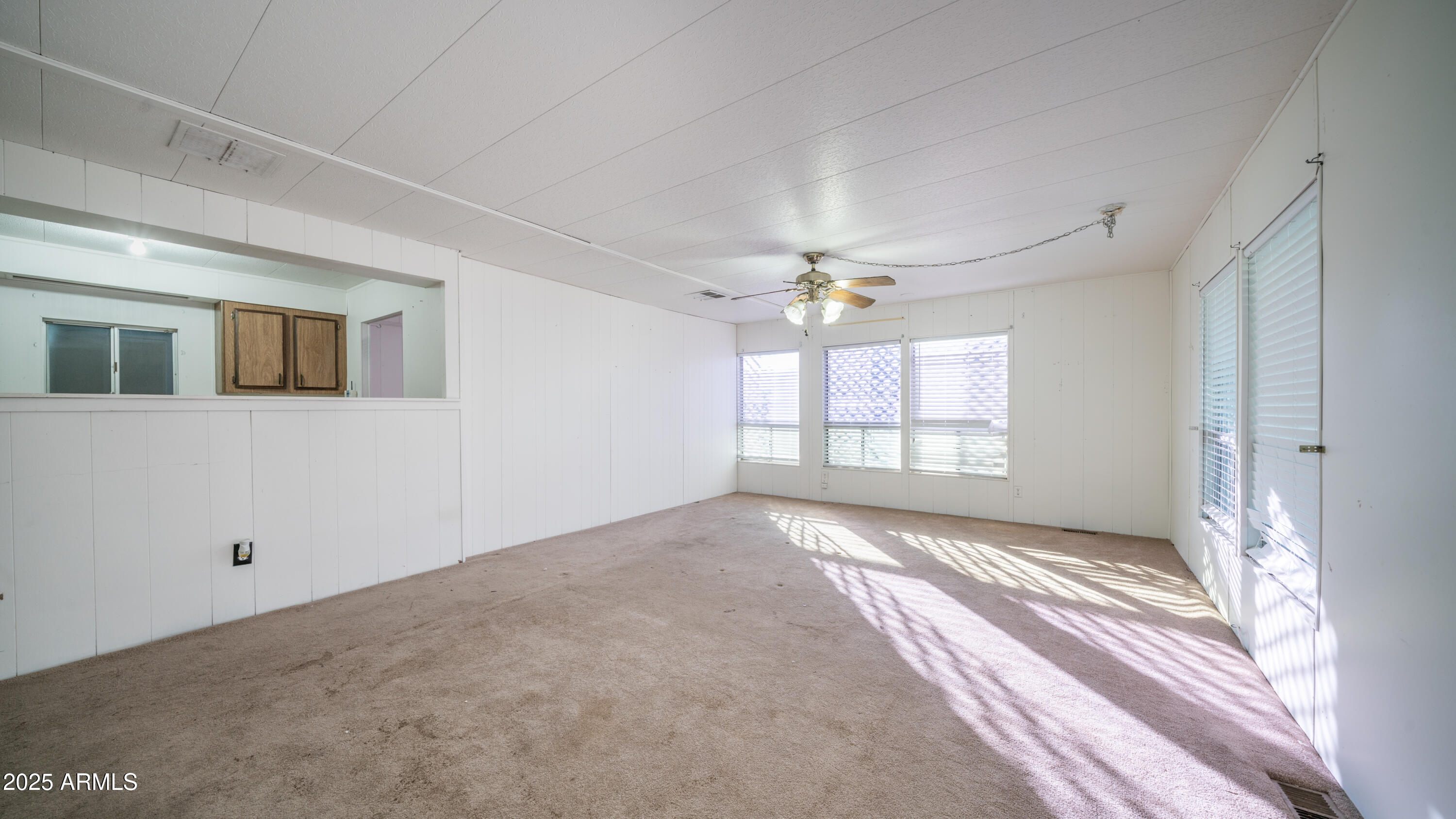 2359 South Tomahawk Road Apache Junction, AZ 85119 - Photo 4 of 32 a view of an empty room with a window