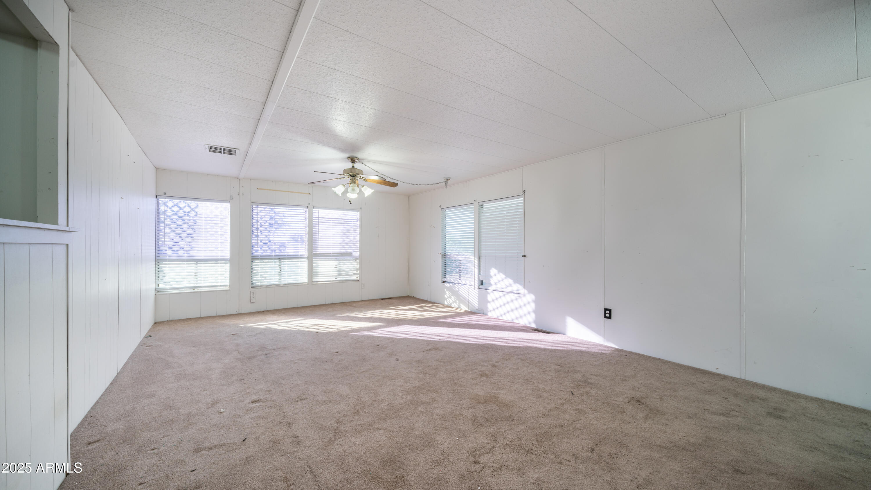 2359 South Tomahawk Road Apache Junction, AZ 85119 - Photo 5 of 32 a view of an empty room with a window