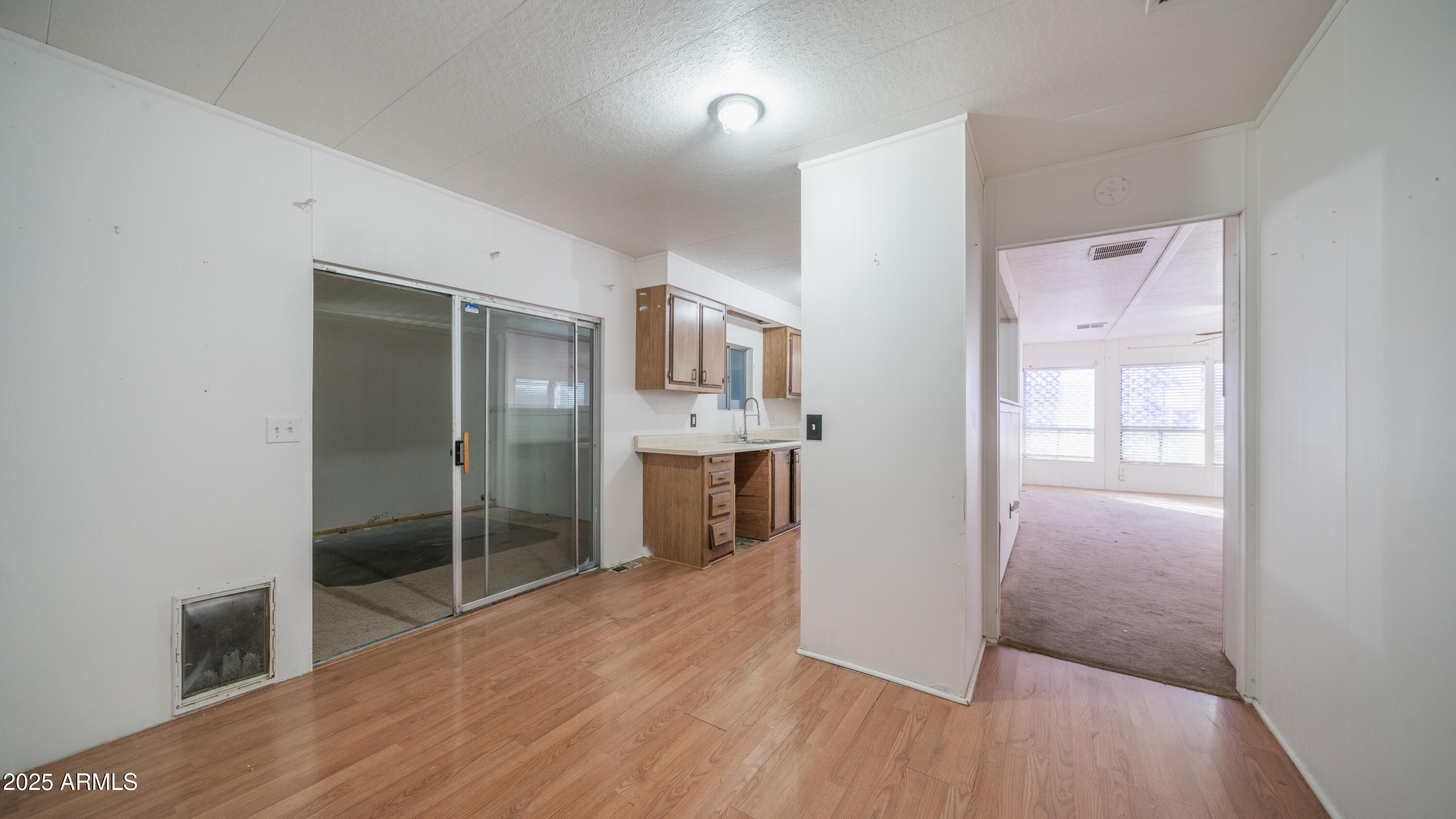 2359 South Tomahawk Road Apache Junction, AZ 85119 - Photo 7 of 32 a view of a hallway with wooden floor and a bathroom
