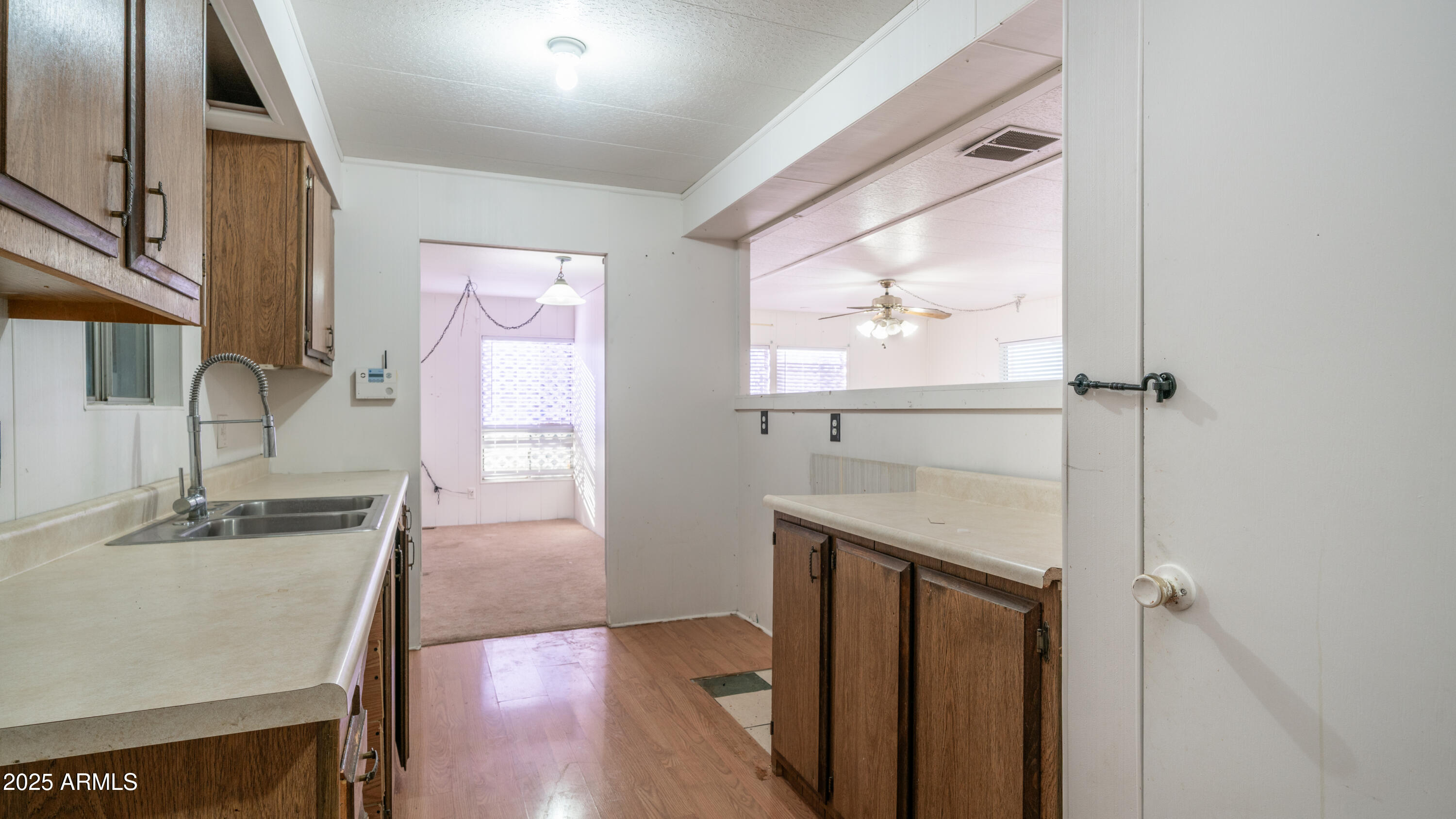 2359 South Tomahawk Road Apache Junction, AZ 85119 - Photo 8 of 32 a bathroom with a granite countertop sink a vanity a window and a mirror