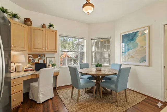 a kitchen with a refrigerator a sink and wooden floor