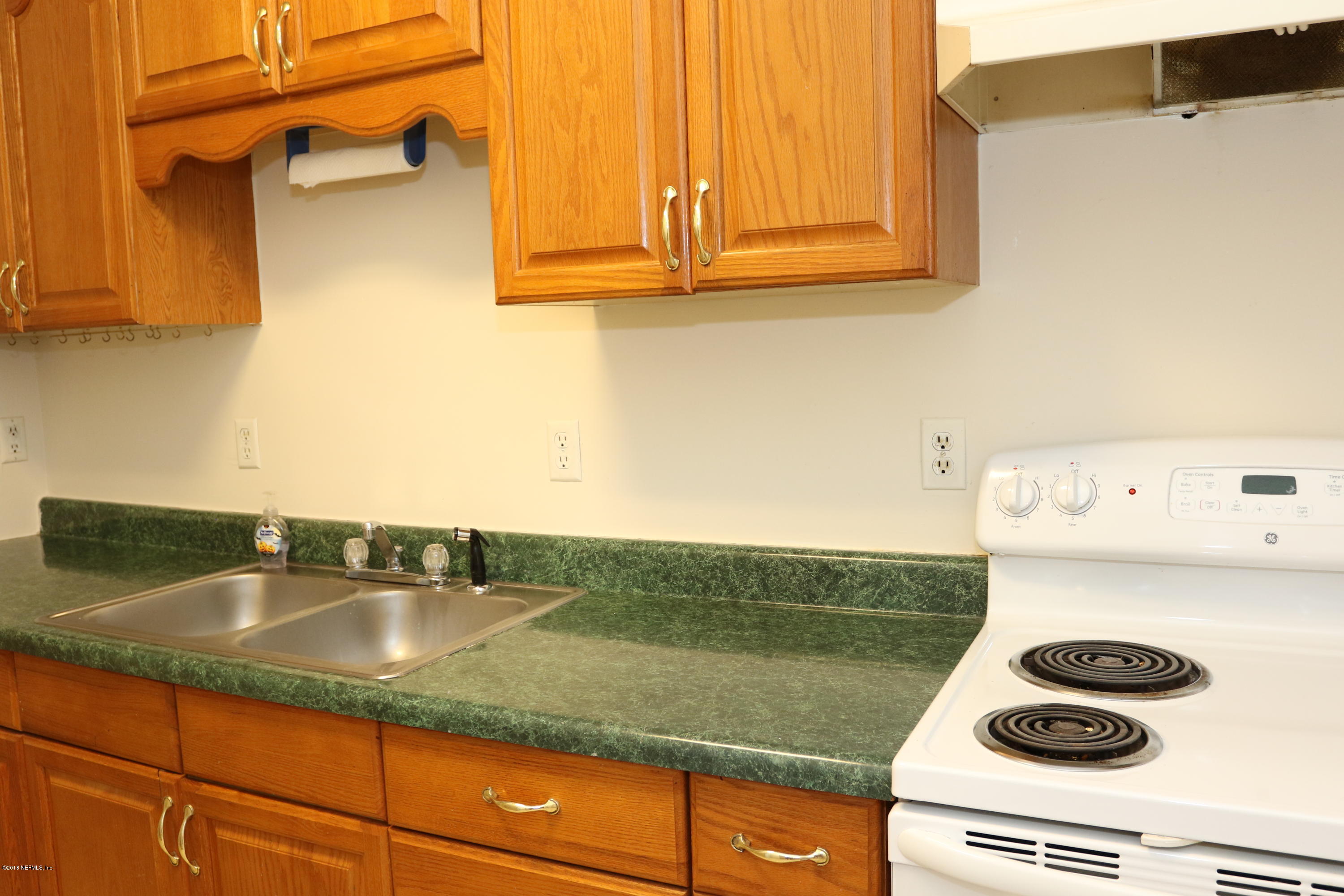4909 Dundee Road Jacksonville, FL 32210 - Photo 11 of 18 a kitchen with a stove and a sink