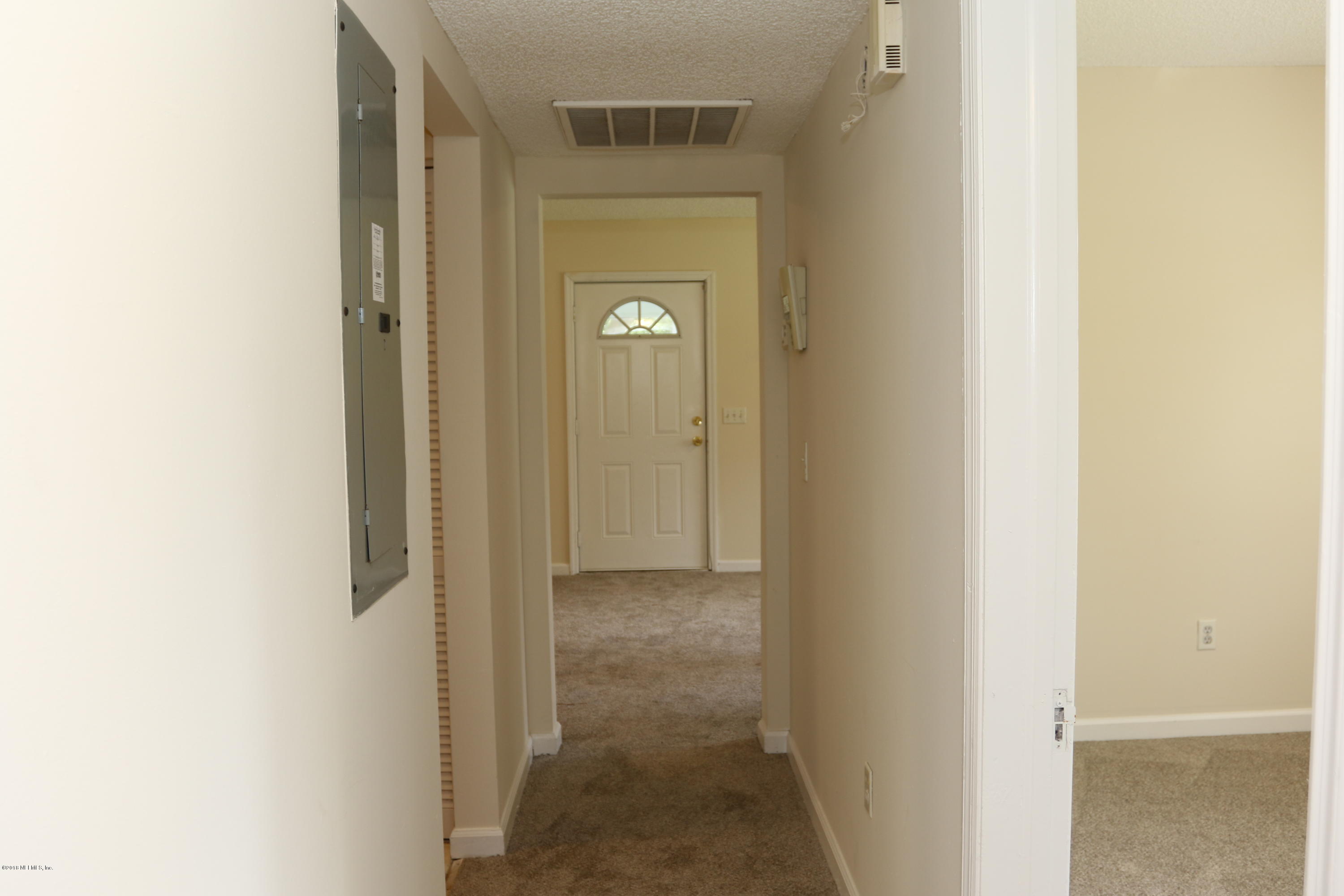 4909 Dundee Road Jacksonville, FL 32210 - Photo 15 of 18 a view of a hallway with closet