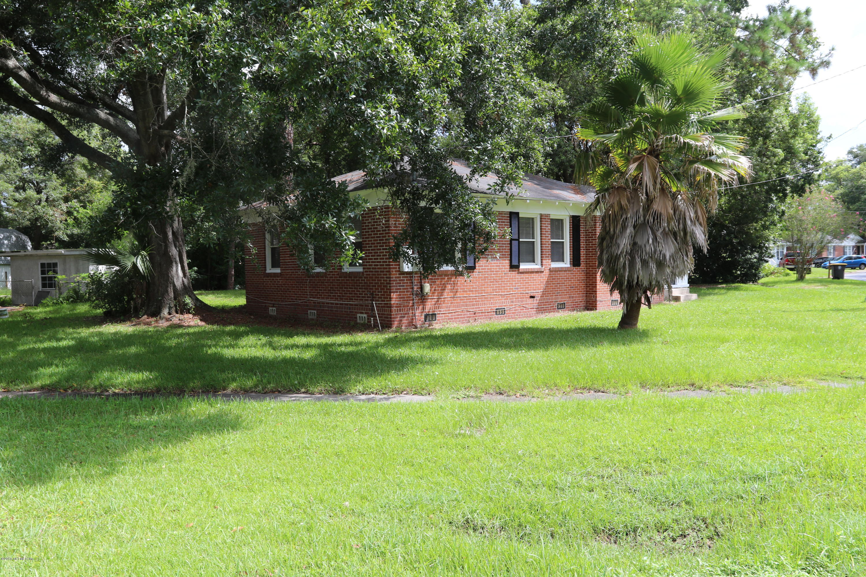 4909 Dundee Road Jacksonville, FL 32210 - Photo 4 of 18 a front view of a house with garden