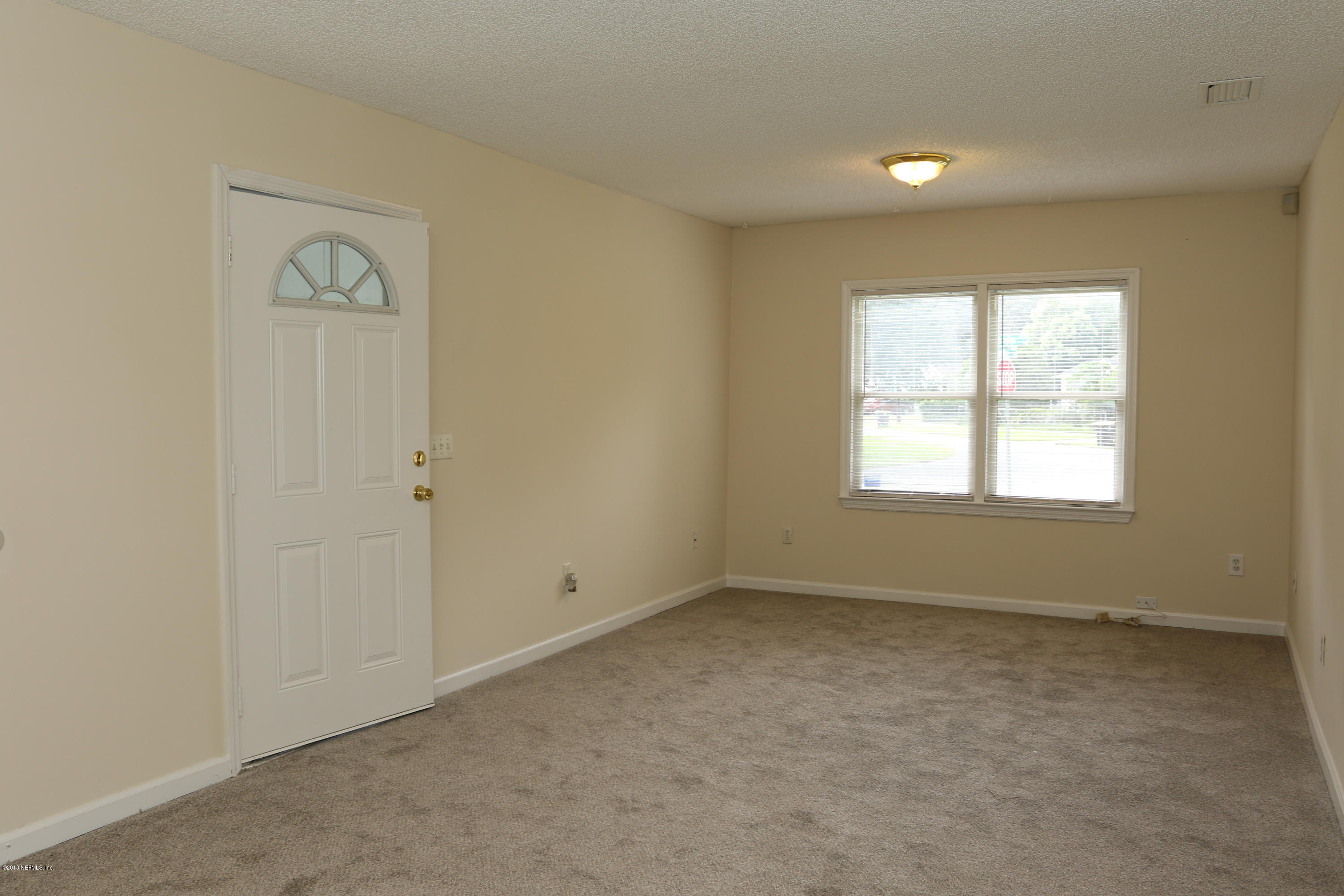 4909 Dundee Road Jacksonville, FL 32210 - Photo 8 of 18 an empty room with window