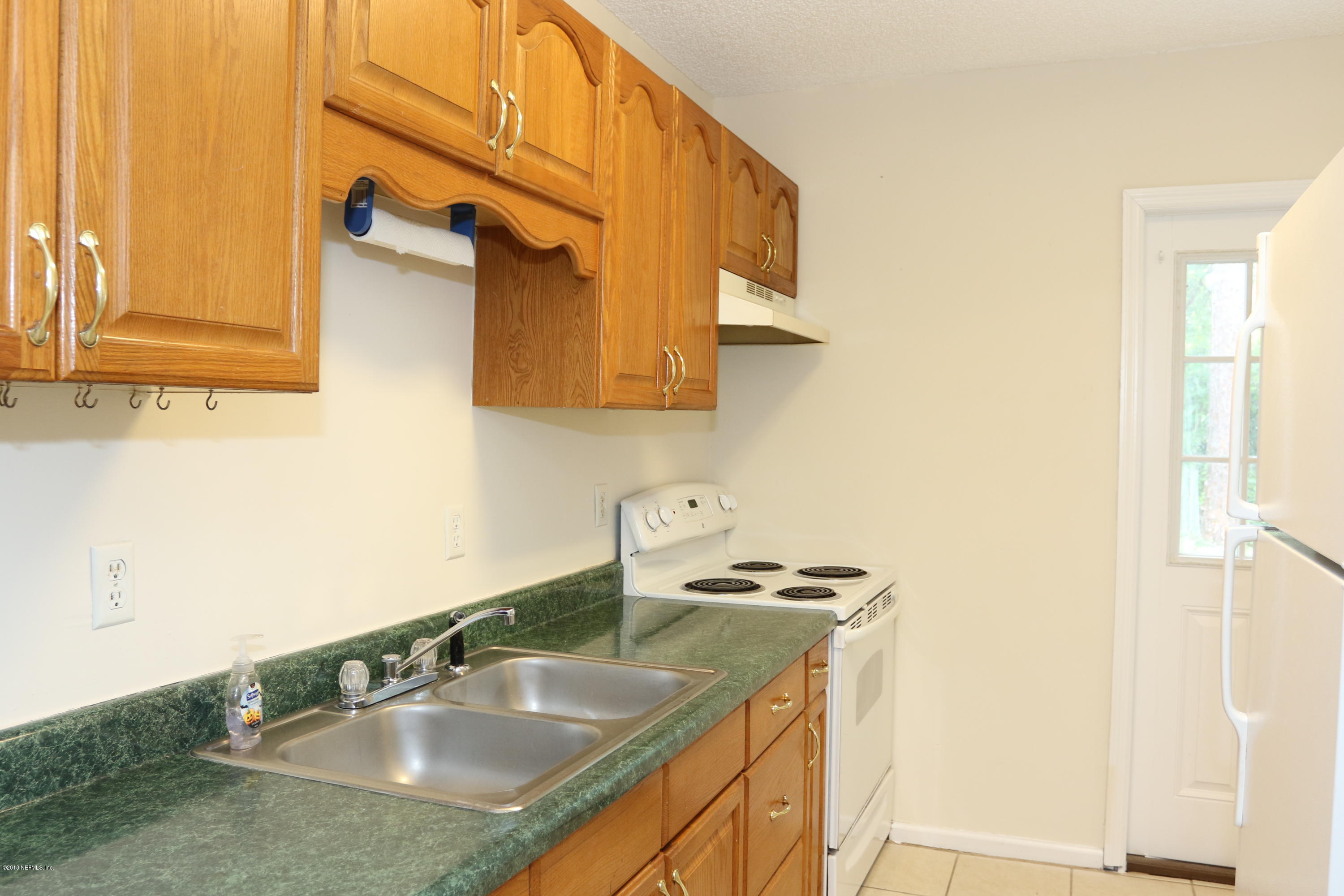 4909 Dundee Road Jacksonville, FL 32210 - Photo 10 of 18 a bathroom with a sink and a mirror