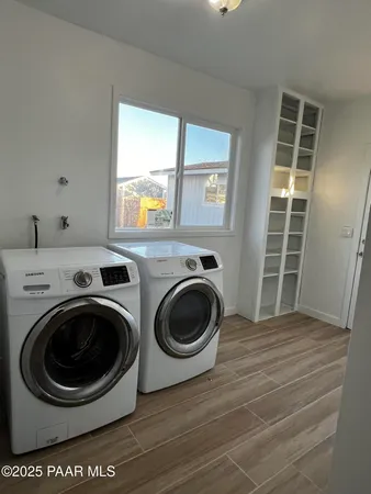 a view of a yard with wooden fence