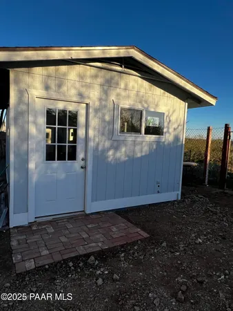 a view of a house with a backyard