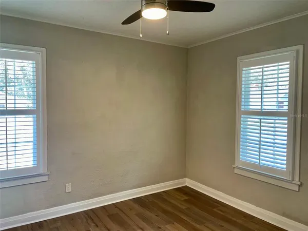 a view of a hallway with wooden floor