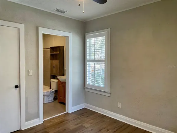 a view of a porch with wooden floor and fence