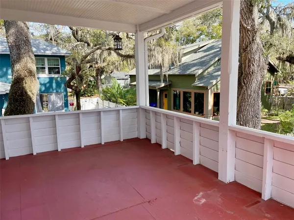wooden floor in a room with a large window