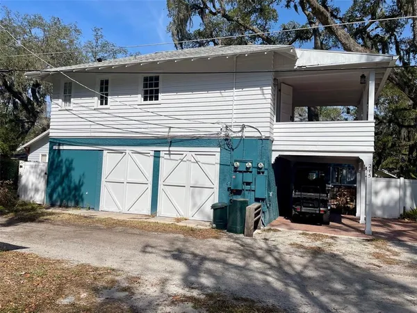 a view of a house with a yard and garage