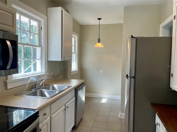 a kitchen that has a sink and a stove in it