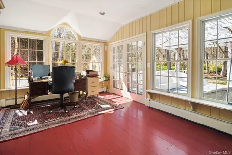 a view of a workspace with furniture and a window