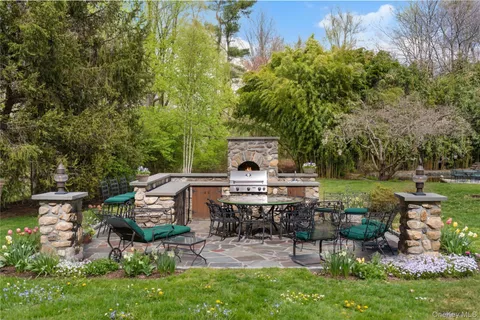 a view of a chair and table in backyard of the house