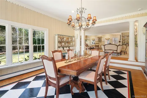 a dining room with furniture a rug and a chandelier