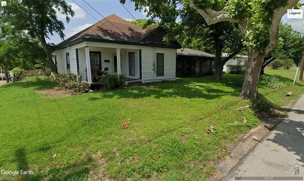 a view of a house with yard and a garden