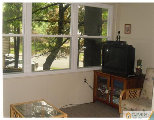 38 Wilk Road Edison, NJ 08837 - Photo 11 of 25 a living room with furniture and a flat screen tv