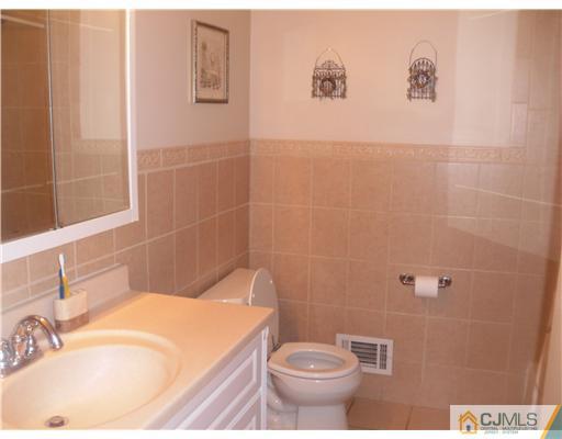 38 Wilk Road Edison, NJ 08837 - Photo 12 of 25 a bathroom with a sink a toilet and shower