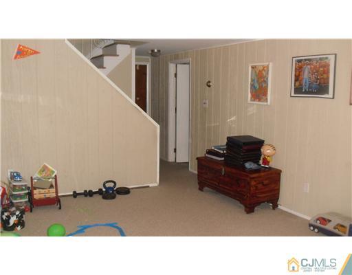 38 Wilk Road Edison, NJ 08837 - Photo 21 of 25 a living room with furniture and a flat screen tv
