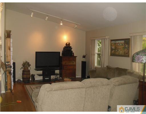 38 Wilk Road Edison, NJ 08837 - Photo 4 of 25 a living room with furniture and a flat screen tv