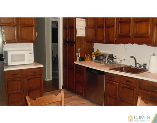38 Wilk Road Edison, NJ 08837 - Photo 5 of 25 a kitchen with a sink cabinets and window