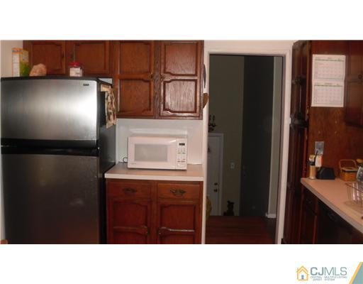 38 Wilk Road Edison, NJ 08837 - Photo 6 of 25 a black and white kitchen with a sink