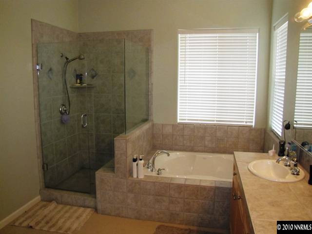 5547 New Mexico Court Reno, NV 89511 - Photo 11 of 12 a bathroom with a bathtub and shower