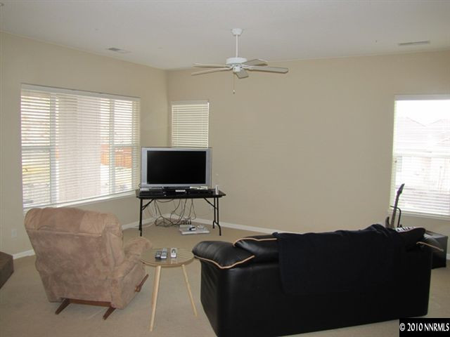 5547 New Mexico Court Reno, NV 89511 - Photo 2 of 12 a living room with furniture and a flat screen tv