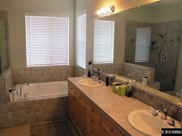 5547 New Mexico Court Reno, NV 89511 - Photo 10 of 12 a bathroom with a tub sink and mirror