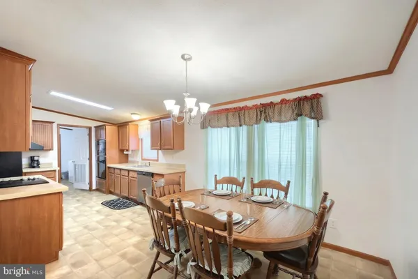 a view of a dining room with furniture and chandelier