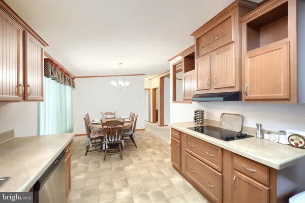 a kitchen with granite countertop a sink and cabinets