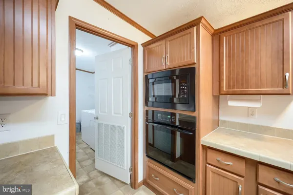 a kitchen with a refrigerator and cabinets